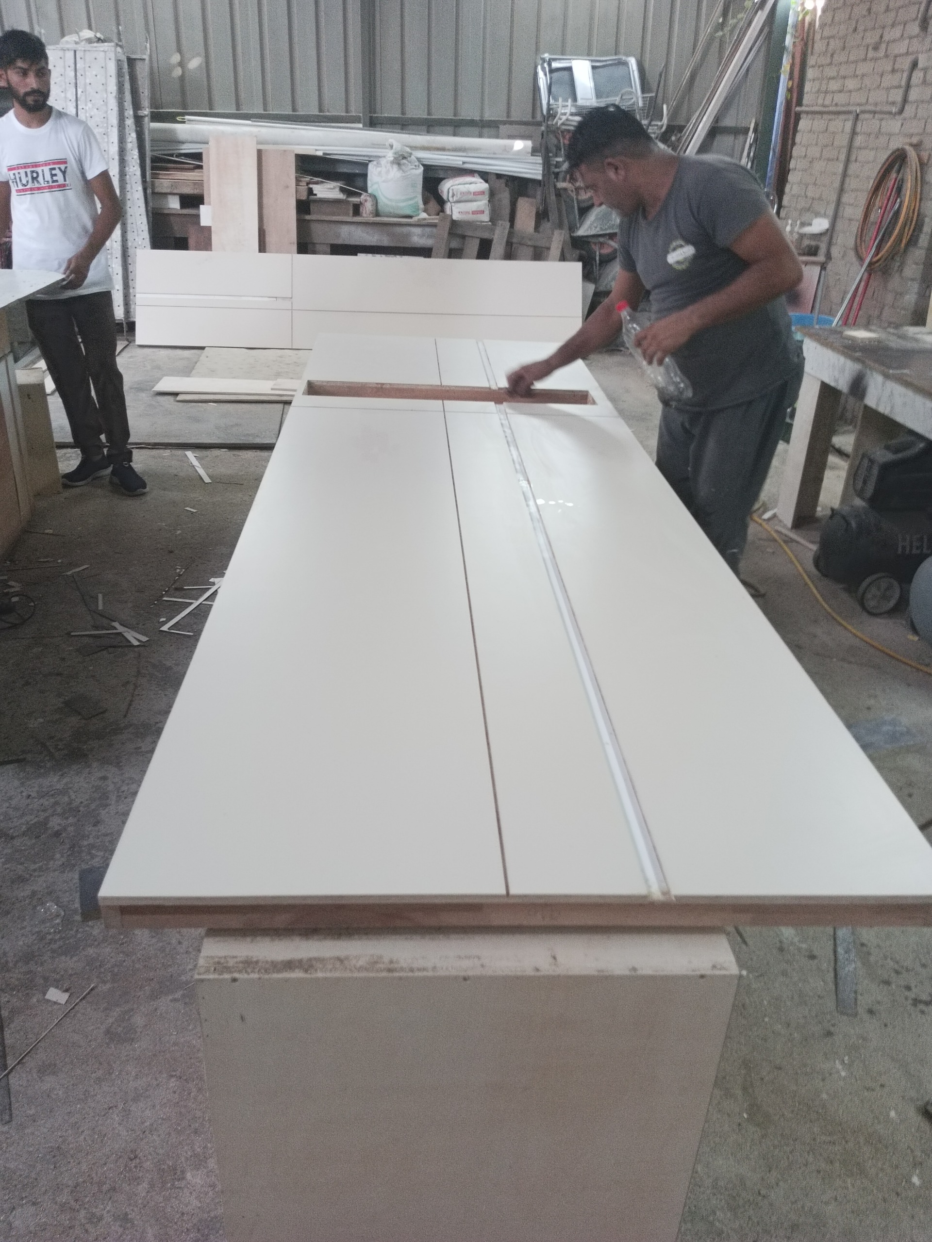 Our workshop team finishing a custom furniture panel